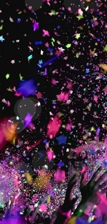 Lively explosion of colorful confetti against a dark background at night.