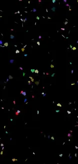 Colorful confetti scattered on a black background.