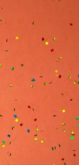 Colorful confetti on a vibrant orange background, perfect for mobile wallpaper.