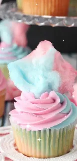 Colorful cotton candy cupcake with pink and blue frosting.