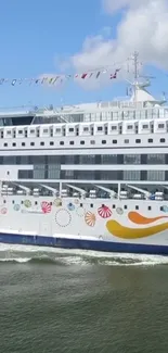 Vibrant cruise ship sailing on a calm blue ocean.