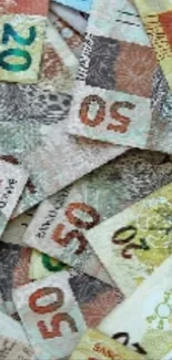 Assorted foreign banknotes laid out in a colorful collage.