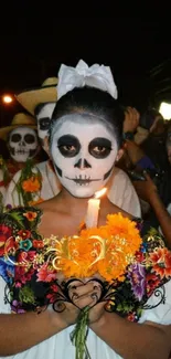 Day of the Dead celebration with colorful face paint and flowers.