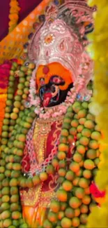 Deity adorned with colorful beads and rich traditional attire.