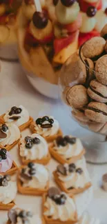 A diverse selection of desserts on a table, featuring pastries, fruit, and sweets.