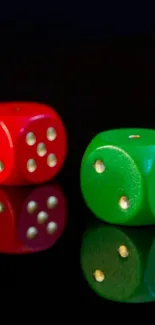 Red and green dice reflected on black.