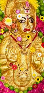 Gold deity adorned with colorful flowers in a vibrant display.