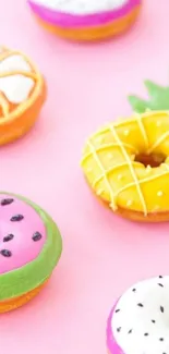 Colorful donuts on a pastel pink background.