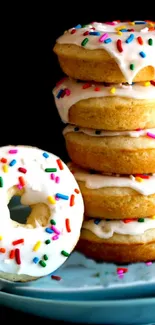 Stack of glazed donuts with colorful sprinkles on a plate.