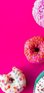 Vibrant pink background with colorful donuts and sprinkles.