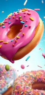 Colorful donut with pink icing and sprinkles against a blue background.