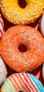 A colorful array of frosted donuts in a vivid pattern.