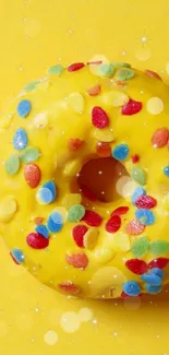 Yellow donut with colorful sprinkles on a phone wallpaper.