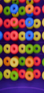 Colorful donuts on a purple background mobile wallpaper.