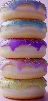 Stack of colorful donuts with pastel icing and sprinkles.