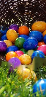 Vibrantly colored Easter eggs in a woven basket on grass.