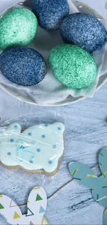 Colorful Easter eggs with paper bunnies on decorative display.