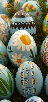 Colorful Easter eggs with floral and animal designs on pine needles.