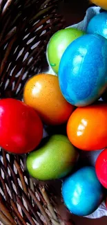 Colorful Easter eggs in a wicker basket phone wallpaper.