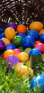 Colorful Easter eggs in a basket on green grass.