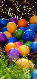 Colorful Easter eggs spilling from a wicker basket onto green grass.