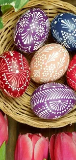 Colorful Easter eggs in a wicker basket with tulip accents.