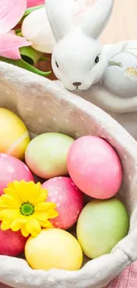 Colorful Easter eggs in a basket with a ceramic bunny and flowers.