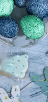 Colorful Easter eggs and spring decorations on a light blue textured surface.