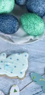 Colorful speckled eggs with decorative cookie on display.