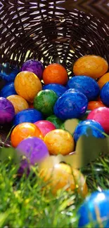 Colorful Easter eggs spill from a basket onto green grass.