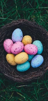 Colorful Easter eggs in a nest on green grass.