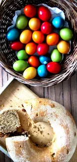 Colorful Easter eggs in a basket and a loaf of bread on a rustic wood surface.