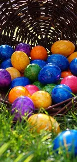 Colorful Easter eggs spilling from a wicker basket on green grass.