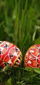 Colorful Easter eggs with intricate patterns resting in green grass.