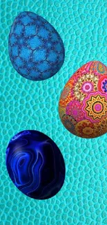 Three colorful eggs on teal textured background.