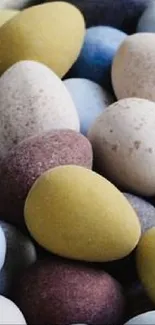 Colorful assorted egg-shaped stones wallpaper.