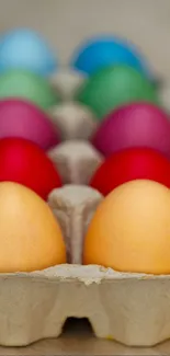 A carton containing colorful eggs arranged neatly.