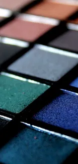 Diverse colorful eyeshadow palette with deep blues and greens.