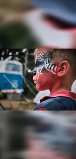 Young boy with face paint set against an outdoor background.