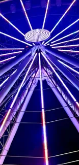 Colorful Ferris wheel illuminated at night.