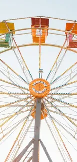 Colorful Ferris wheel against a bright sky.