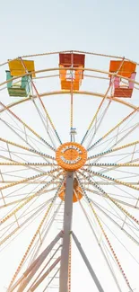 Colorful Ferris wheel against a clear blue sky.