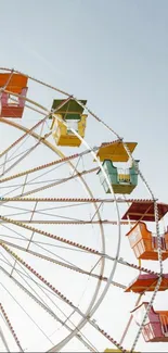 Colorful Ferris wheel under a clear blue sky, perfect for a vibrant mobile wallpaper.