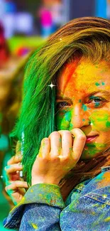 Festive woman with colorful face paint at a vibrant festival.