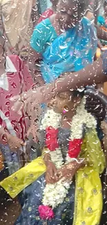 Festive gathering with colorful attire and rain-soaked glass in the foreground.