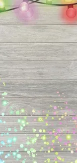 Colorful festive lights with sparkles on a wooden background.