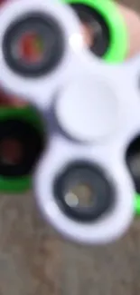 Blurry fidget spinner with a neon green detail.