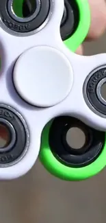 A vibrant fidget spinner with green and gray colors for stress relief.