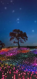 Colorful illuminated field under a tranquil night sky with tree silhouette.