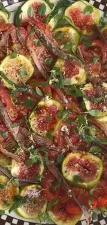 Colorful platter of figs and tomatoes with herbs.